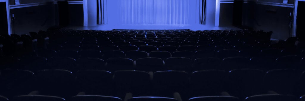 Moody blue lit stage at The Palace Theatre Arts Commons